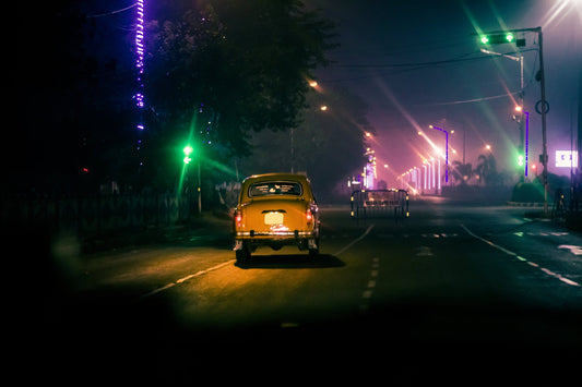 Taxi driving down a city street at night